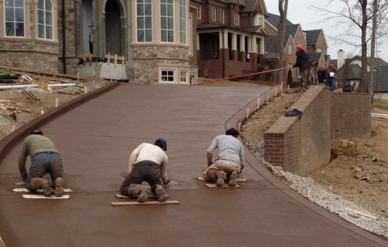 finishing integral color concrete driveway